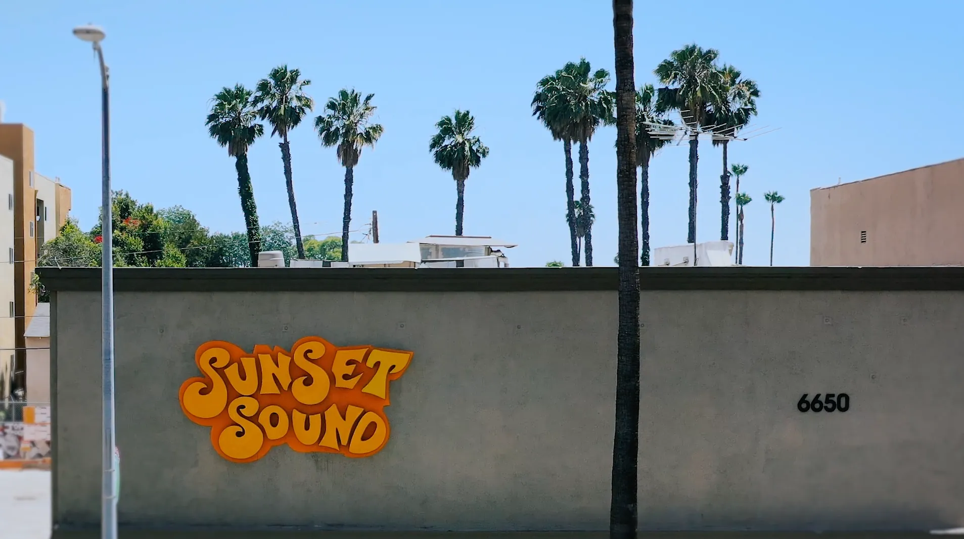 The Sunset Sound studio wall under palm trees in Los Angeles